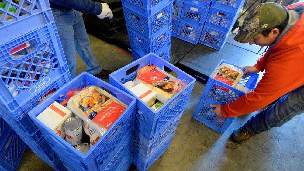 A picture of blue crates of food being distribute by Augusta County Schools employees.